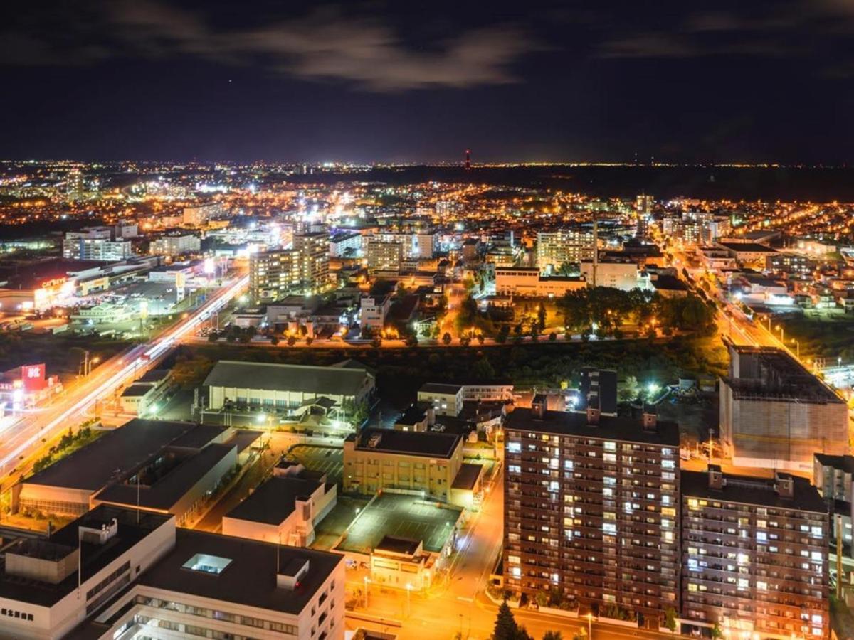 Hotel Emisia Sapporo Exterior foto Aerial view of the city at night